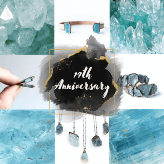 Aquamarine and sterling silver raw crystal gemstone rings, bracelets and necklaces on black textured background