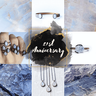 Raw iolite gemstones and sterling silver jewelry, including rings, necklaces and bracelets featuring 21st anniversary gemstone iolite and alternate moonstone on black stone.