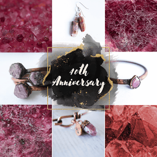 Raw ruby gemstones set in sterling silver cage pendants and earrings, gold vermeil stacking rings with ruby accents, and sterling silver chain necklaces featuring faceted ruby beads